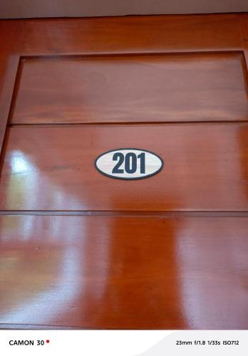 a wooden door with the number on it at EPM Tower Hotel and Events Place in Alfonso