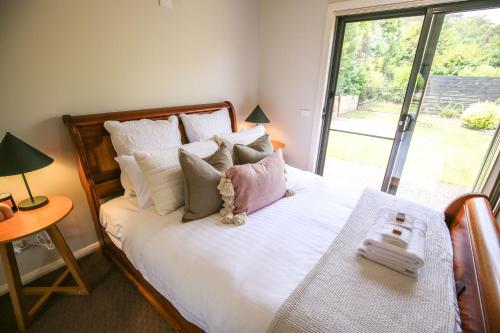 a bedroom with a bed with a teddy bear on it at Alpine Nest in Bright