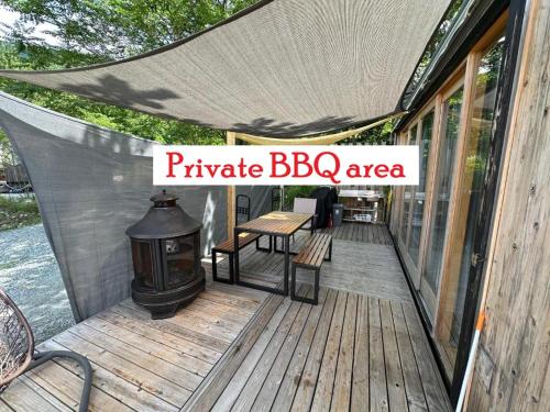 a wooden deck with a barbecue barbecue bbq area at Fuji Dome Glamping in Fujikawaguchiko