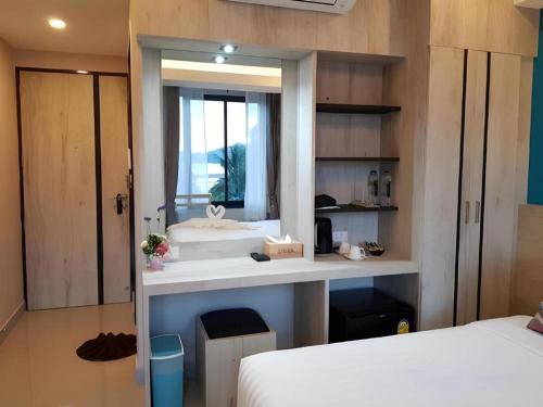 a bathroom with a sink in a room with two beds at SEESEA RESORT in Amphoe Langu