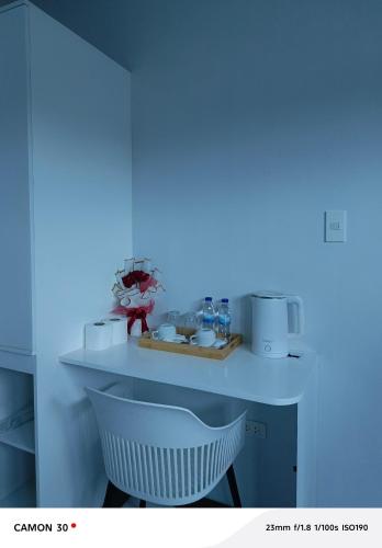 a white counter with two white chairs in a room at EPM Tower Hotel and Events Place in Alfonso
