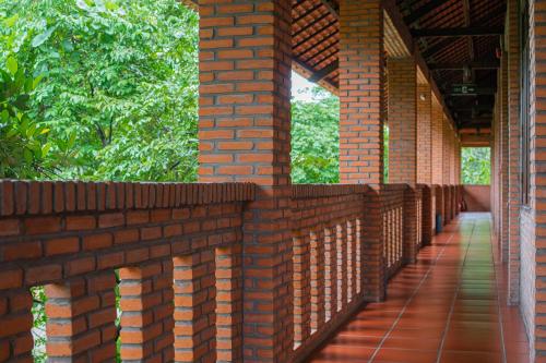 a brick wall with a walkway on it at Mekong Long Thanh Resort & Reststop in Ấp Thanh Nguyên