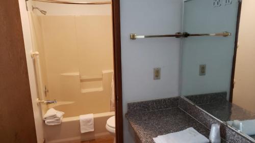 a bathroom with a shower and a sink and a toilet at Hotel O Rama Inn & RV Park in Washougal