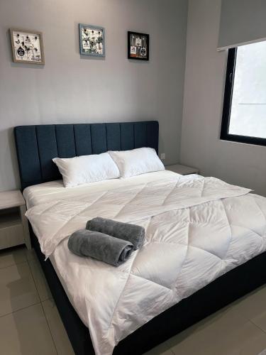 a large bed with two pillows on top of it at Wanderlust Retreat Studio by Iconic Regency in Bayan Lepas