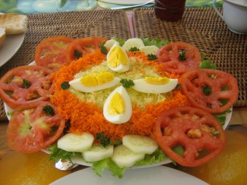 a plate of food with eggs and tomatoes on it at Amigo 2 in Cap Skirring