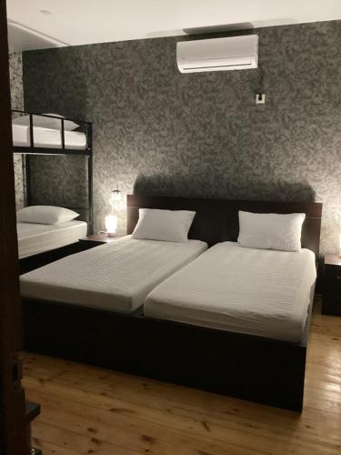 two beds in a room with two bunk beds at Mountain breeze in Lagodekhi