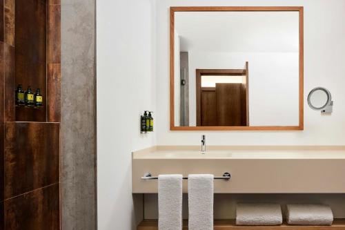 a bathroom with a sink and a mirror at Marriott Residences Salgados Resort, Algarve in Albufeira