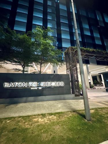 a sign in front of a building with the name eviction refugees at Eaton Residences By Classic in Kuala Lumpur