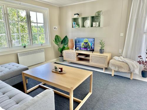 a living room with a couch and a table at Panoramablick - Meer - Familien - Remote Work in Fjällbacka