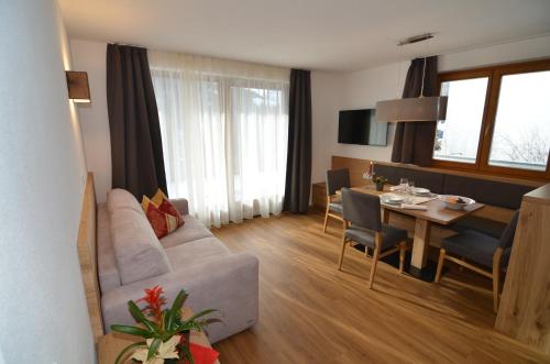 a living room with a couch and a dining room at Villa Paröis in La Valle