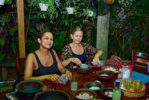 a man and a woman sitting at a table at Ella Soul Nest Glamping Tent for Nature Lovers in Ella