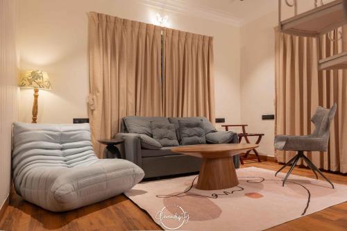 a living room with a couch and a table at Villa Serendipity Aldona in Aldona