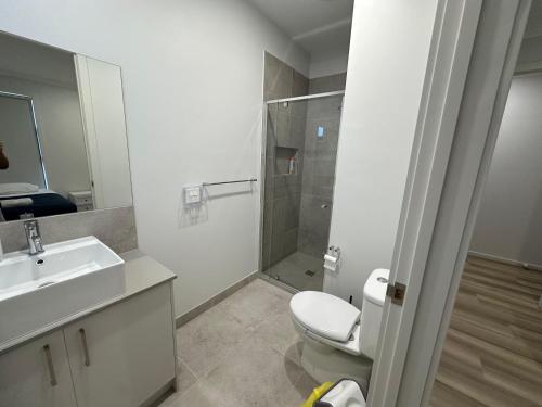 a bathroom with a shower and a toilet and a sink at Special Retreat-Beveridge in Beveridge