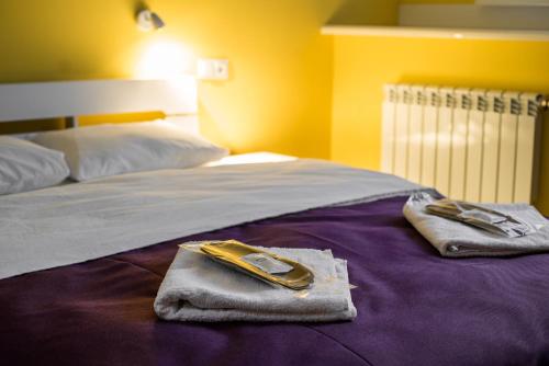 a bed with towels and towels on top of it at Апартаменты WOW-hotel in Kyiv