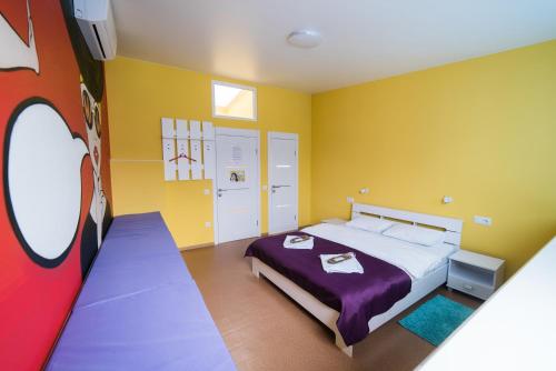 a bedroom with a bed and yellow walls at Апартаменты WOW-hotel in Kyiv