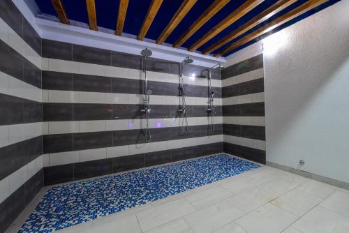 a bathroom with a shower with blue and white tiles at Boutique Apartments Ad Astra in Bibinje