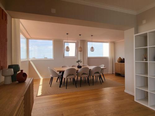 a dining room with a table and chairs at Sea View, 2 BR, Terrace & Garage in São Domingos | By Airnest in São Domingos de Rana
