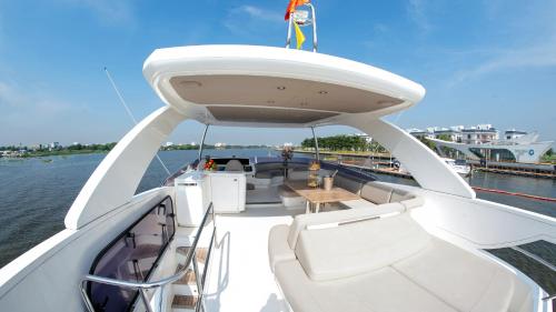 a person standing on the top of a boat in the water at Saigon Luxury Private Yacht Prestige 590 - Managed by Vietyacht Club in Ho Chi Minh City
