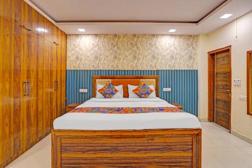 a bedroom with a large bed in a room at Via Angel Pink Residency in Ghaziabad
