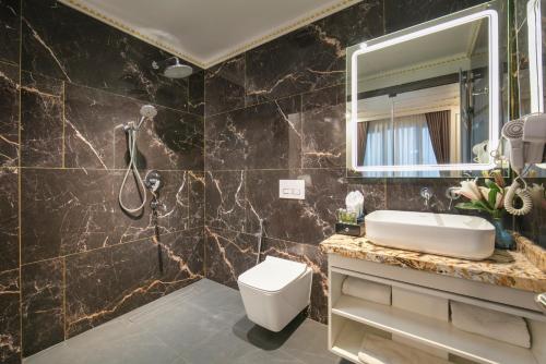 a bathroom with a sink and a mirror at Royal Dương Nội Hotel in Hanoi