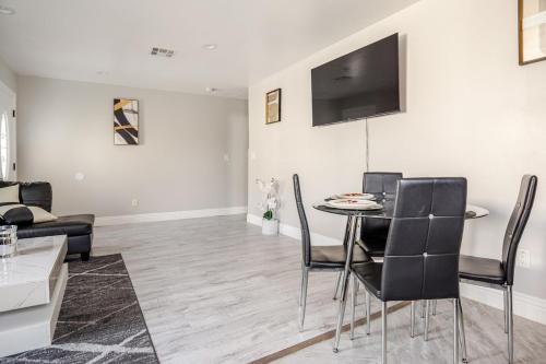 a living room with a table and chairs at charming home in LA prime location in Los Angeles