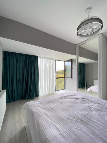 a bedroom with a large bed and a large mirror at 5 TH AVENUE - Bakuriani in Bakuriani
