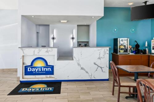 a restaurant with a day inn sign on the wall at Days Inn by Wyndham Salina South in Salina
