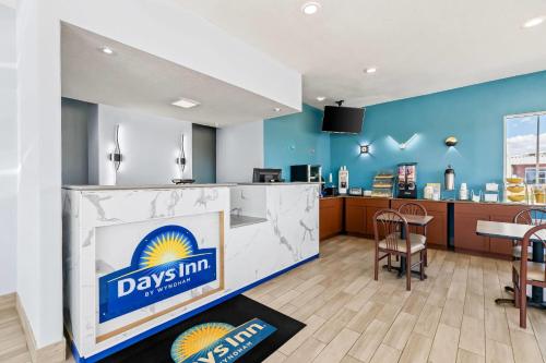 a large lobby with a day inn sign on a counter at Days Inn by Wyndham Salina South in Salina