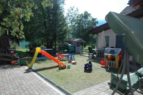 a playground with many different types of play equipment at Chalet Valeruz in Canazei