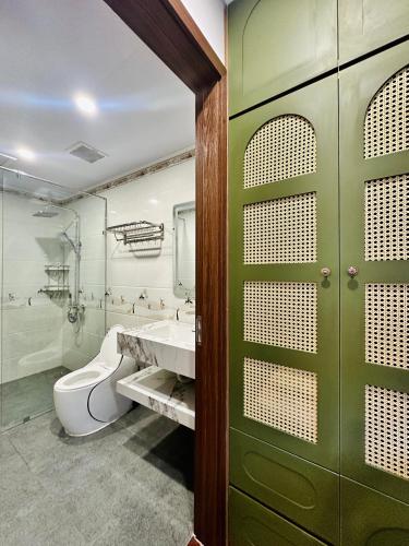 a bathroom with a toilet and a sink at Momento Phu Quoc Hotel in Phu Quoc
