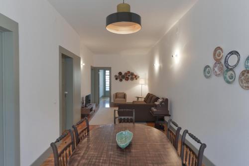 a dining room and living room with a table and chairs at Jardim do Embaixador Apartments by LovelyStay in Lisbon