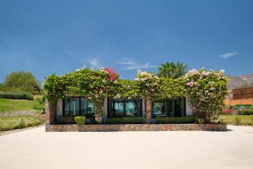 a house with flowers on the side of it at Playa de La Paz by Lumina in La Paz