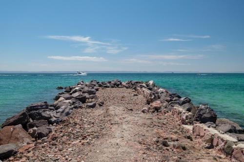 a group of rocks on the shore of the ocean at Playa de La Paz by Lumina in La Paz