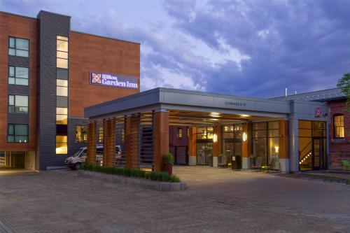 a building with a parking lot in front of it at Hilton Garden Inn Burlington Downtown in Burlington