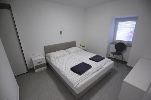 Ένα ή περισσότερα κρεβάτια σε δωμάτιο στο Gaja & Sara Apartments
