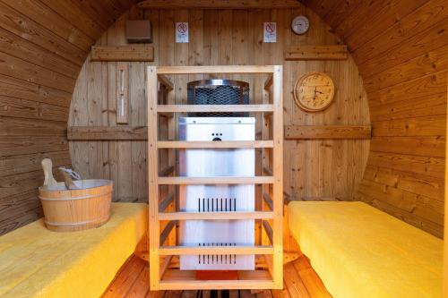 a room with a shelf in a cabin with a clock at Kiyonoya in Asakura