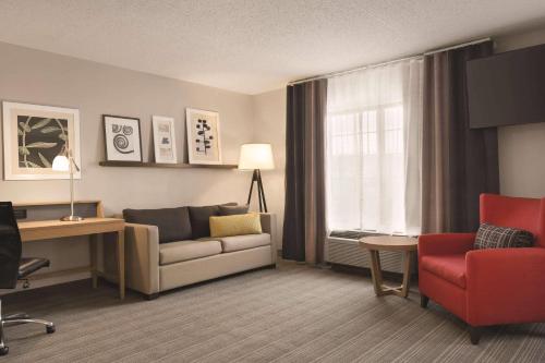 a living room with a couch and a chair at Country Inn & Suites by Radisson Raleigh-Durham Airport NC in Morrisville