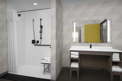 a bathroom with a sink and a mirror at Home2 Suites By Hilton Sevierville in Pigeon Forge
