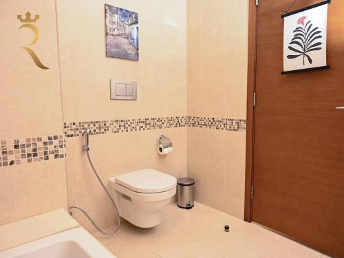 a bathroom with a toilet and a shower at Supernova Haven 1BR - Peaceful Poolside Getaway Near Yas Mall & Marina in Abu Dhabi