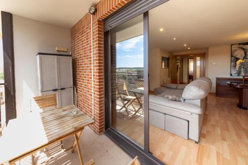 a living room with sliding glass doors leading to a balcony at Casa Venerable Carabantes in Soria
