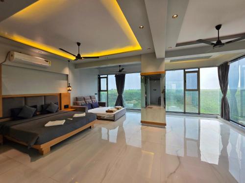 a large living room with a bed and a couch at Relax Adventure Resort in Igatpuri