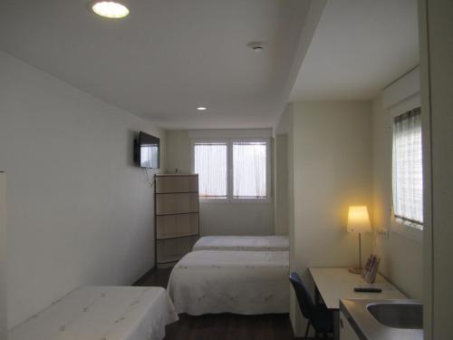 Postel nebo postele na pokoji v ubytování Hostal El Estudio