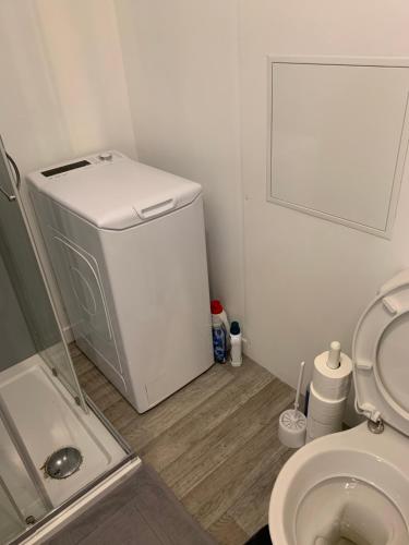 a small bathroom with a toilet and a small refrigerator at Studio 2 A3M Locations in Limay