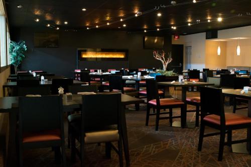 a dining room filled with tables and chairs at Ramada by Wyndham Indiana in Indiana