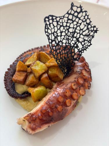a plate of food with a piece of meat and potatoes at Hotel Valle Rossa in San Giovanni Rotondo