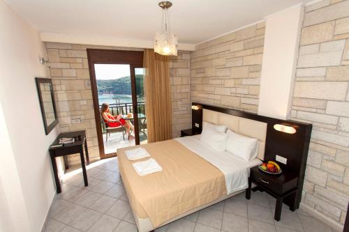 a bedroom with a bed and a balcony at Pelagos in Parga