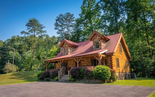 a large wooden house with a red roof at Holden On in Pigeon Forge
