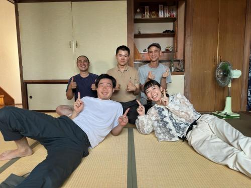a group of men are posing for a picture at Guesthouse Azumaya in Matsumoto