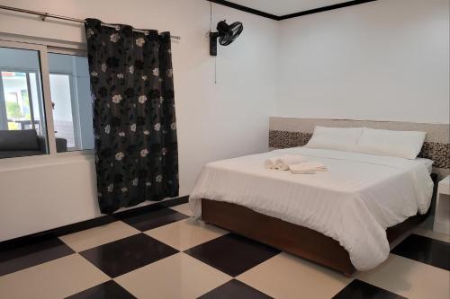 a bedroom with a bed and a checkered floor at Jewelry Resort and Villas Tagaytay in Silang