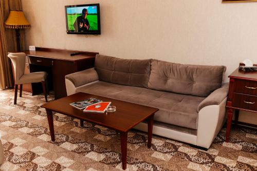 a living room with a couch and a table at Capitol Hotel Stay in Baku